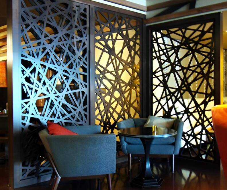 Geometric pattern design on wooden panels separating tables in a restaurant