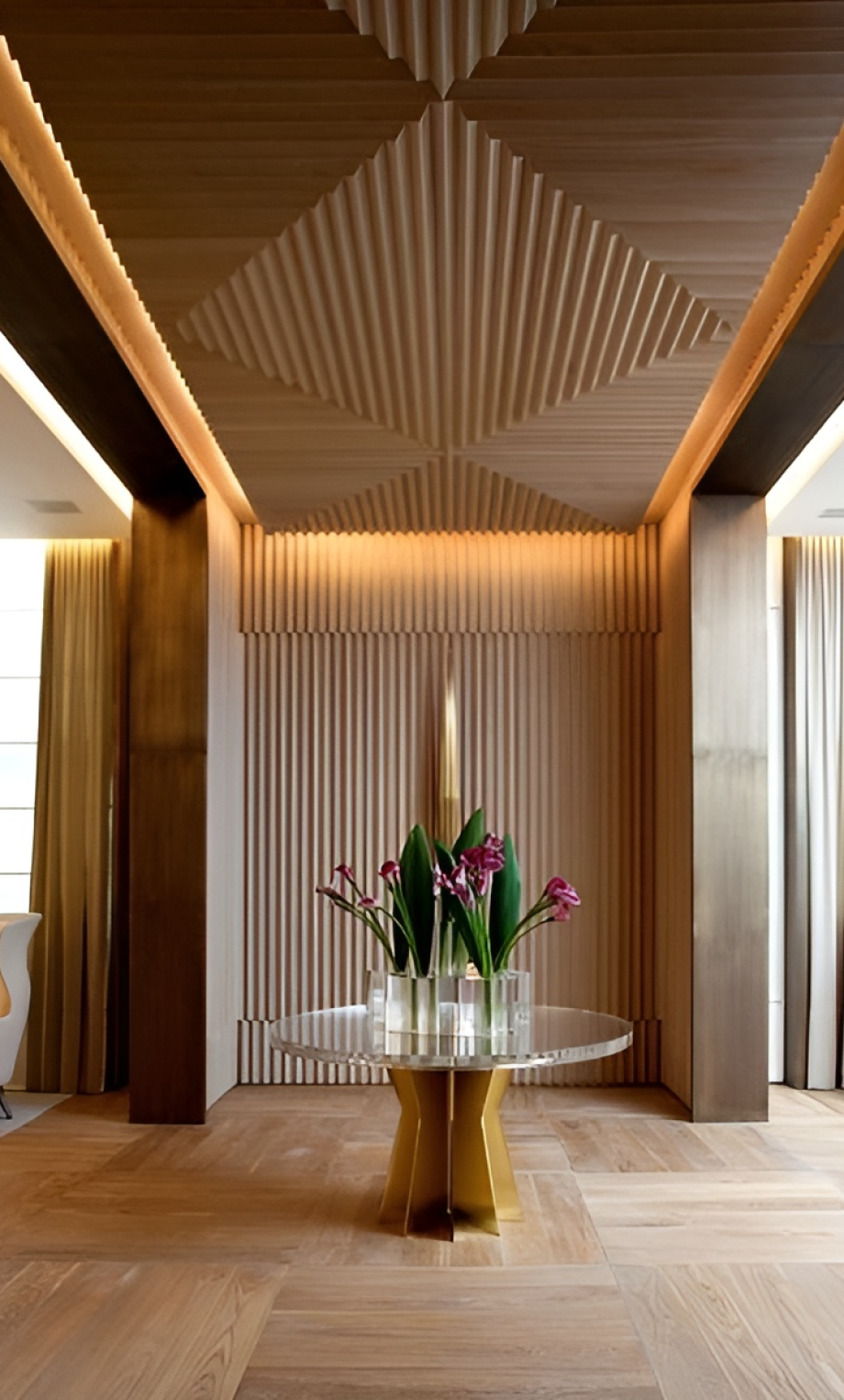 A living room with a bouquet on a table surrounded by sound dampening or decorative slat panels.